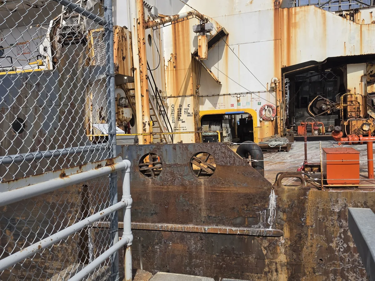 Regulatory markings on a workboat, demonstrating durable signage in a harsh environment.